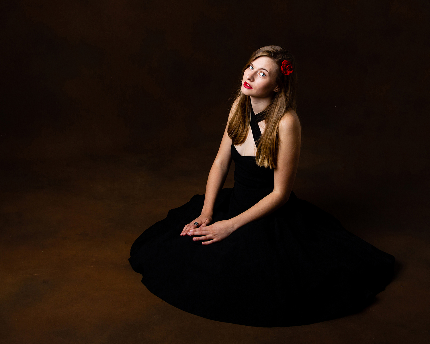 Beautiful lady wearing long black dress red lipstick and red flower in her hair sitting, Glamour Portrait | Michaela Howe Photography