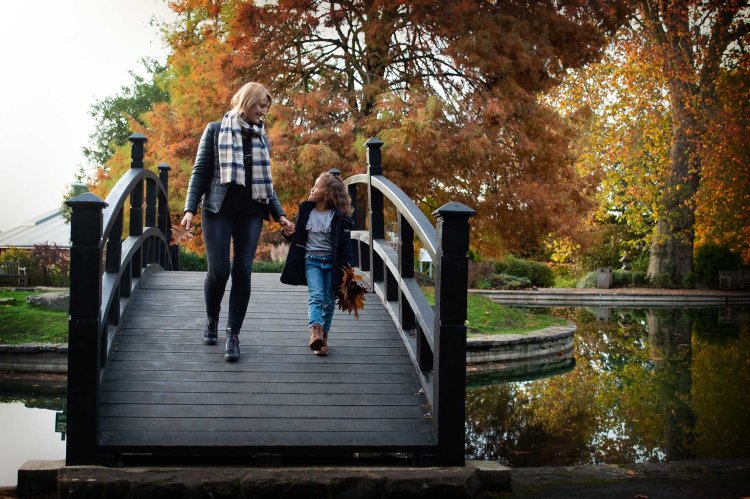 autumnal family photoshoot mum and daughter walking on bridge landscape | Michaela Howe Photography