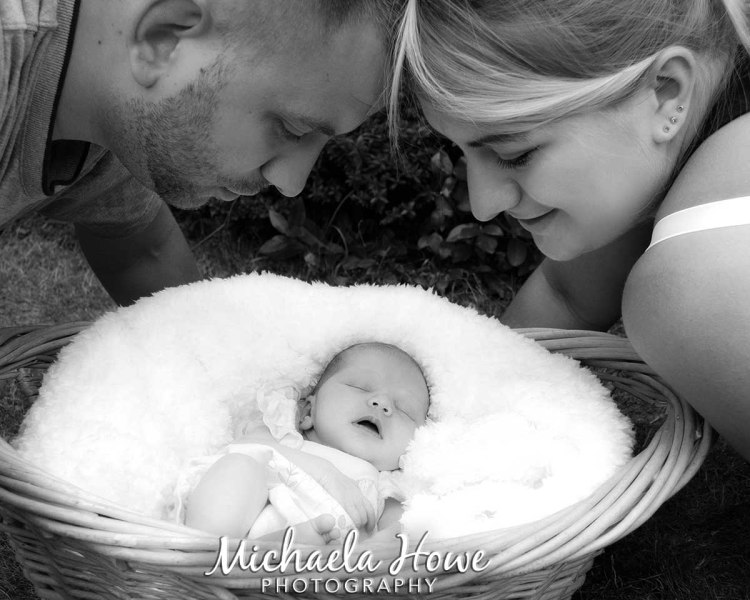 newborn baby in basket family photo black and white